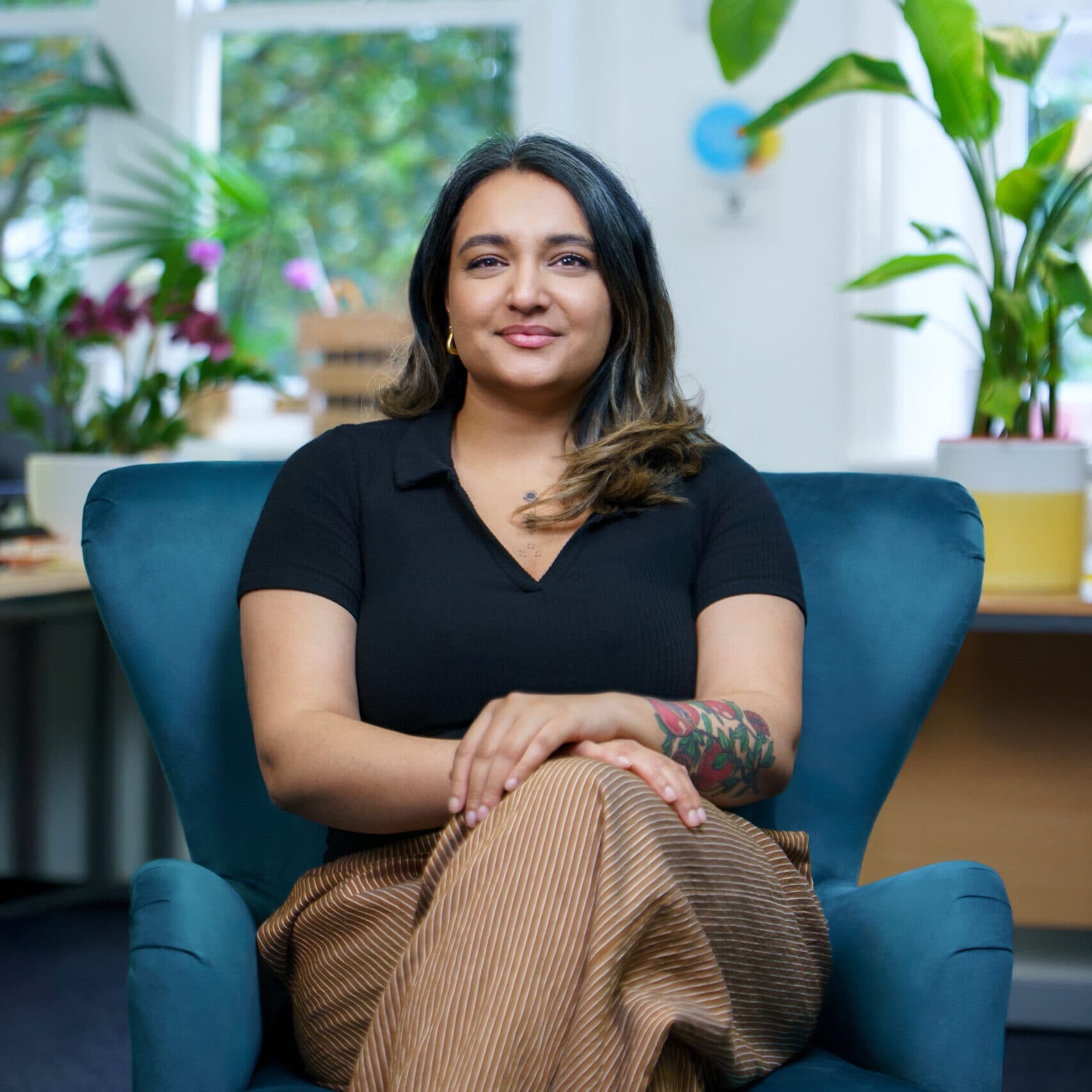 Image of Nishma Jethwa sitting and smiling